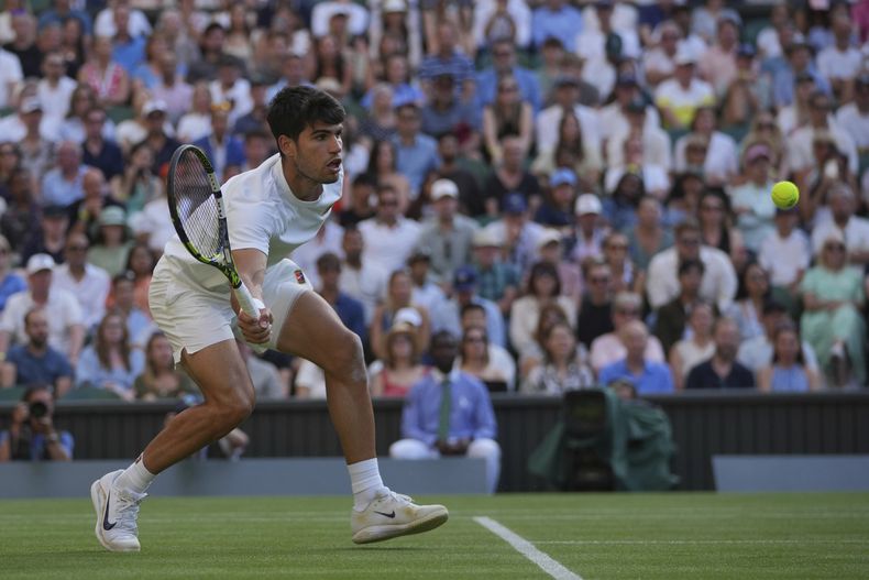 Carlos Alcaraz de España devuelve a Jan-Lennard Struff de Alemania durante un partido individual masculino de tercera ronda en el Campeonato de Tenis de Wimbledon en Londres, el viernes 4 de julio de 2025. (AP Photo/Kin Cheung)
