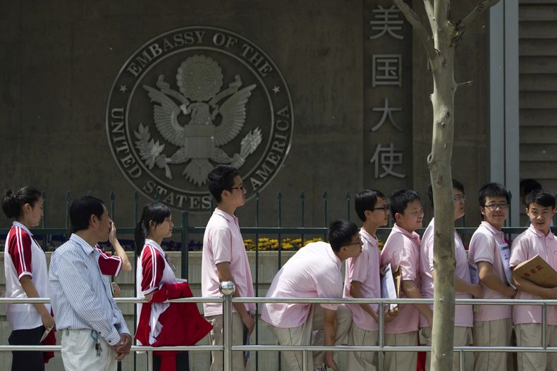 ARCHIVO - Estudiantes chinos aguardan afuera de la embajada de Estados Unidos para sus entrevistas de solicitud de visa, el 2 de mayo de 2012, en Beijing. (AP Foto/Alexander F. Yuan, archivo)