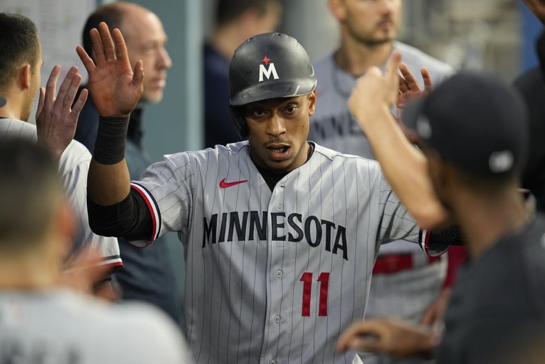 El dominicano Jorge Polanco, de los Mellizos de Minnesota, festeja en la cueva tras anotar en el juego ante los Dodgers de Los Ángeles, el lunes 15 de mayo de 2023 (AP Foto/Ashley Landis)