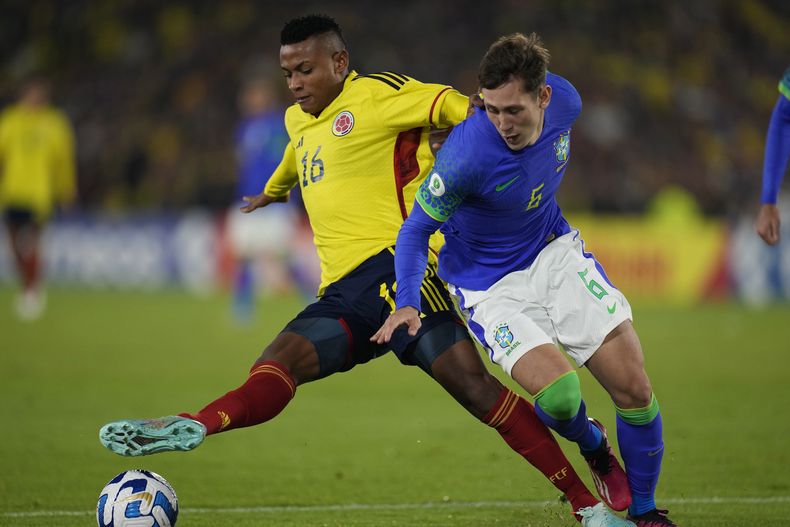 ARCHIVO - El colombiano Óscar Cortés (izquierda) pugna el balón con el brasileño Patryck durante el partido del Sudamericano Sub20, el 9 de febrero de 2023. (AP Foto/Fernando Vergara)
