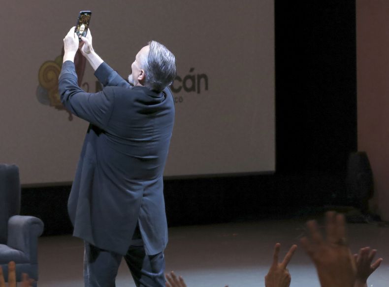 El cantante y actor español Miguel Bosé se toma una selfie con el público durante una charla sobre la película Tacones lejanos en el Festival Internacional de Cine de Morelia en Morelia, México, el lunes 23 de octubre de 2023. (Foto AP/Berenice Bautista)