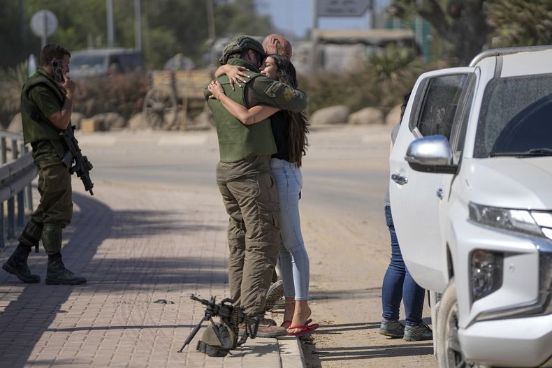 Un soldado israelí abraza a su pareja cerca de la frontera con la Ciudad de Gaza, en el sur de Israel, el 20 de octubre de 2023. El ejército israelí ha reforzado la presencia de tropas terrestres cerca del enclave palestino luego de un inesperado y letal asalto insurgente, a medida que la guerra entre Israel y Hamás se adentra en su segunda semana. (AP Foto/Ohad Zwigenberg)