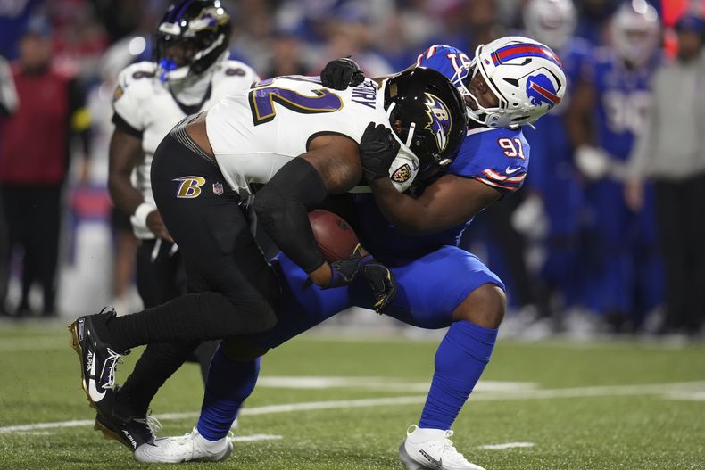 Derrick Henry (22), running back de los Ravens de Baltimore, es derribado por Ed Oliver (91), tackle defensivo de los Bills de Buffalo, durante la segunda mitad del partido de la NFL, el domingo 7 de septiembre de 2025, en Orchard Park, Nueva York. (AP Foto/Gene J. Puskar)