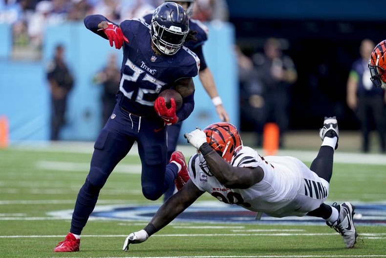 Derrick Henry (22), running back de los Titans de Tennessee, deja atrás a Josh Tupou (68), de los Bengals de Cincinnati, durante la segunda mitad del partido de la NFL, el domingo 1 de octubre de 2023, en Nashville, Tennessee. (AP Foto/George Walker IV)