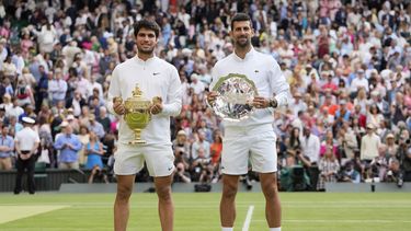 El campeón Carlos Alcaraz posa junto a Novak Djokovic tras la final de Wimbledon, el domingo 16 de julio de 2023, en Londres. (AP Foto/Kirsty Wigglesworth)