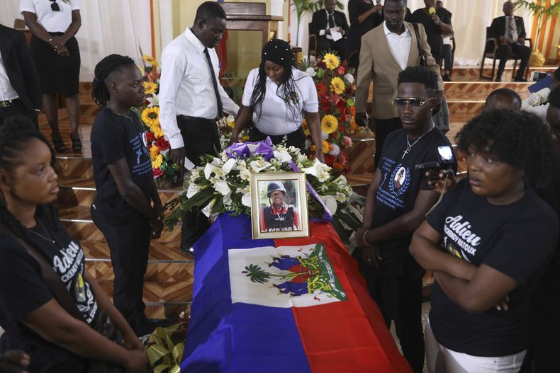 Una fotografía enmarcada del periodista Marckendy Natoux, quien fue asesinado por pandilleros en Navidad cuando cubría la reapertura de un hospital, adorna el ataúd con sus restos durante su funeral, en Puerto Príncipe, Haití, el sábado 18 de enero de 2025.(AP Foto/Odelyn Joseph)