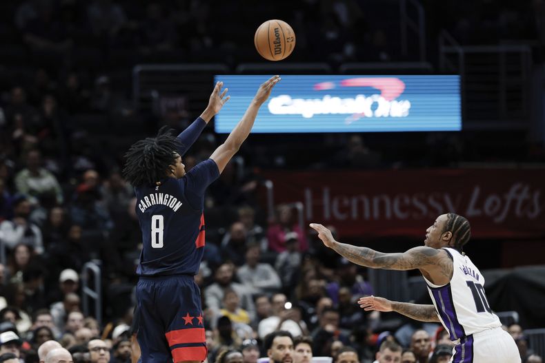 Bob Carrington, base de los Wizards de Washington, intenta un triple frente a DeMar DeRozan, de los Kings de Sacramento, el miércoles 2 de abril de 2025 (AP Foto/Terrance Williams)
