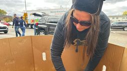 Una voluntaria organiza sandías en un contenedor durante un evento de distribución de alimentos de Forgotten Harvest celebrado en la Iglesia Bíblica Woodside, el viernes 24 de octubre de 2025, en Pontiac, Michigan. (AP Foto/Mike Householder)