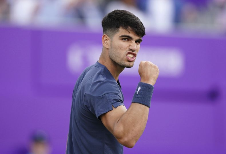 Carlos Alcaraz celebra tras ganar un punto ante Francisco Cerúndolo durante el torneo de Queenss Club, el martes 18 de junio de 2024. (Zac Goodwin/PA vía AP)