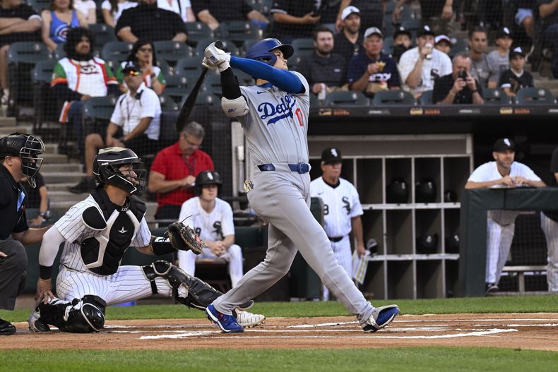 Shohei Ohtani, bateador designado de los Dodgers de Los Ángeles, observa su cuadrangular en contra de los Medias Blancas de Chicago durante la primera entrada del juego de béibsol del miércoles 26 de junio de 2024, en Chicago. (AP Foto/Matt Marton)