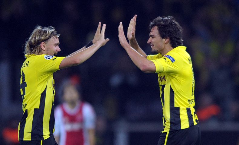 Los zagueros de Borussia Dortmund, Marcel Schmelzer, izquierda, y Mats Hummels, festejan tras ganar un partido por la Liga de Campeones el 18 de septiembre de 2012, en Dortmund, Alemania.(AP Photo/dpa,Federico Gambarini,File)
