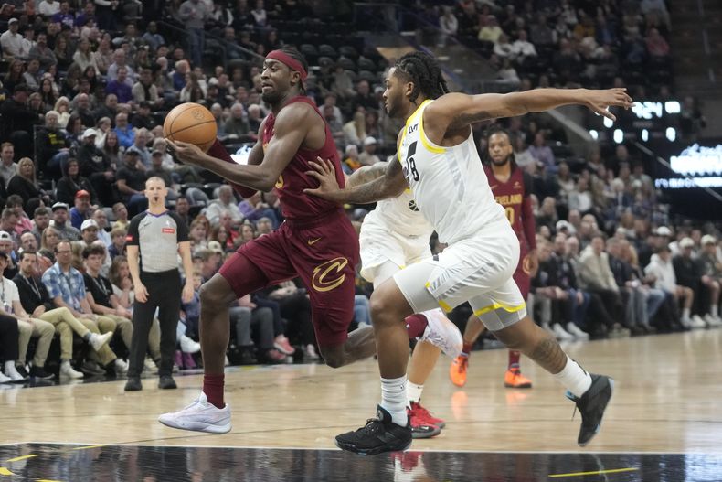 El armador de los Cavaliers de Cleveland Cris LeVert (izquierda) conduce mientras es defendido por el escolta del Jazz de Utah Brice Sensabaugh (8) durante la primera mitad del juego de baloncesto de la NBA, el martes 2 de baril de 2024, en Salt Lake City. (AP Foto/Rick Bowmer)