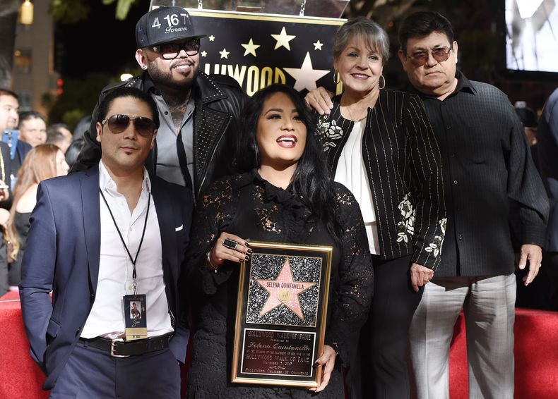 ARCHIVO - Suzette Quintanilla, en el centro, hermana de la fallecida cantante Selena Quintanilla, sostiene una réplica de la estrella de Selena en el Paseo de la Fama de Hollywood mientras posa con, de izquierda a derecha, el esposo de Selena, Chris Pérez, su hermano A.B. Quintanilla III y sus padres Marcella Ofelia Samora y Abraham Quintanilla Jr. durante una ceremonia póstuma en el Paseo de la Fama de Hollywood en Los Ángeles el 3 de noviembre de 2017. (Foto Chris Pizzello/Invision/AP, archivo)