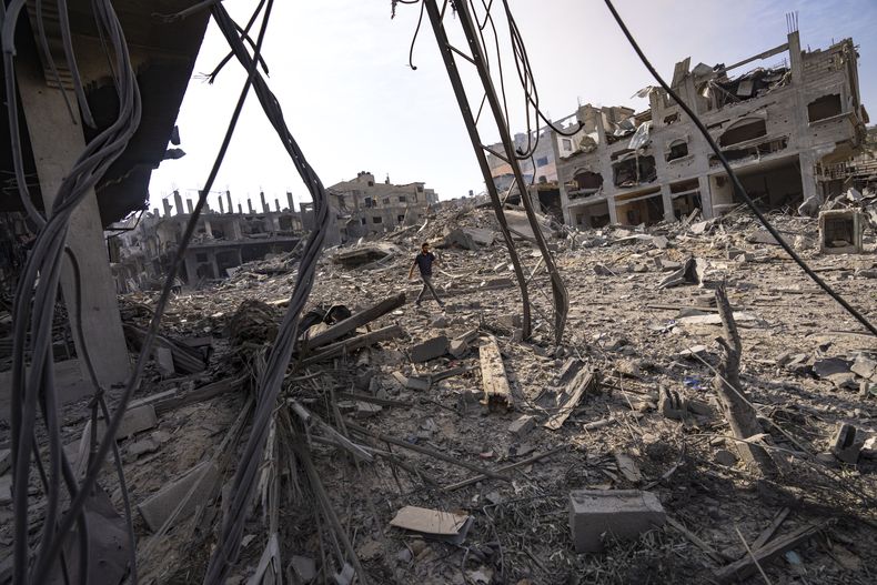 Un palestino camina entre la destrucción causada por los ataques aéreos israelíes en la Ciudad de Gaza, el 11 de octubre de 2023. (AP Foto/Fatima Shbair)