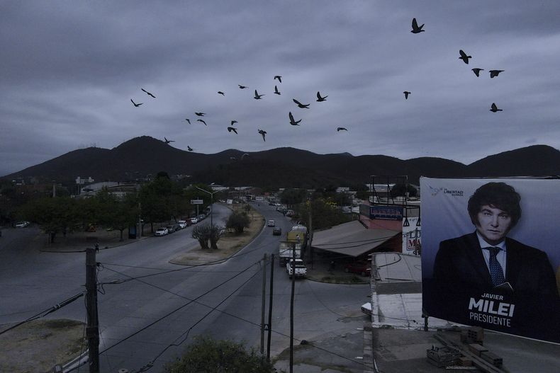 Una bandada de pájaros sobrevuela un cartel del aspirante presidencial Javier Milei en Salta, Argentina, el miércoles 4 de octubre de 2023. Milei, un populista de derechas que admira a Donald Trump y que se ha hecho un nombre al proclamar contra la casta política en televisión, se encuentra como favorito para las elecciones presidenciales. (AP Foto/Javier Corbalán)