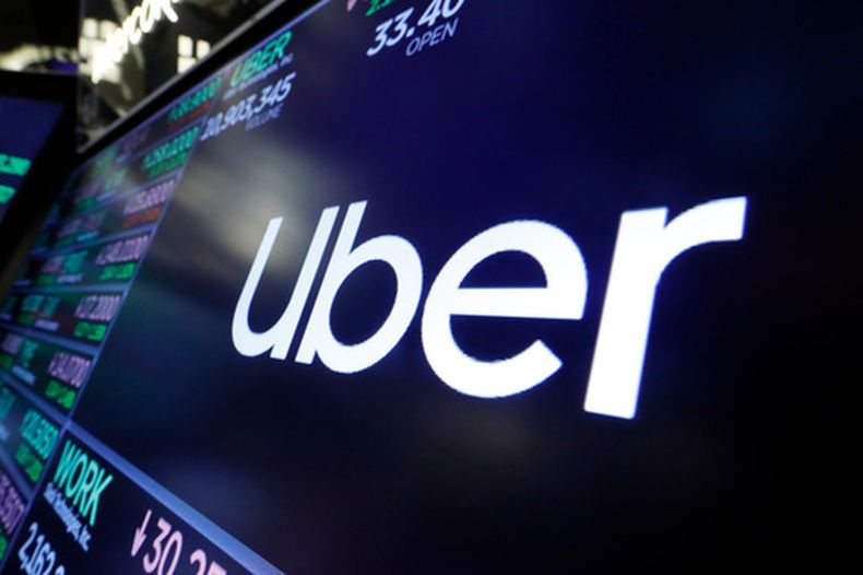 ARCHIVO - El logo de Uber se ve sobre un puesto de operador en la sala de operaciones en la Bolsa de Nueva York, el 16 de agosto de 2019. (AP Foto/Richard Drew, Archivo)