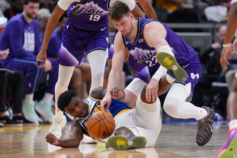 Kyle Filipowski, pívot del Jazz de Utah, disputa un balón perdido con Kam Jones, de los Pacers de Indiana, el martes 3 de febrero de 2026 (AP Foto/Michael Conroy)