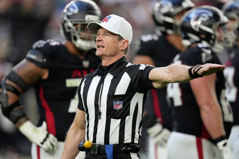 ARCHIVO - El árbitro Land Clark anuncia un castigo durante la segunda mitad del partido de la NFL entre los Cardinals de Arizona y los Falcons de Atlanta, el domingo 21 de diciembre de 2025, en Glendale, Arizona. (AP Foto/Ross D. Franklin, Archivo)