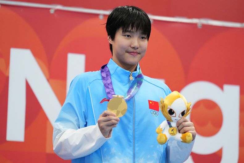 La medallista oro china Yu Zidi posa en el podio tras ganar los 200 metros combinados en los Juegos Asiáticos, el lunes 21 de septiembre de 2026, en Tokio. (AP Foto/Hiro Komae)